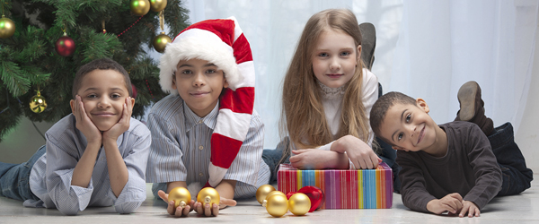 Children holding Christmas gifts