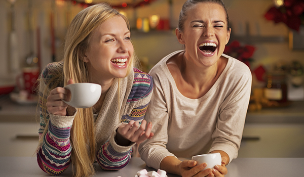 Celebrating Christmas Away From Home - with two friends laughing while holding a cup