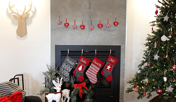 Nordic Christmas with personalised stockings hanging in a fireplace and a christmas tree