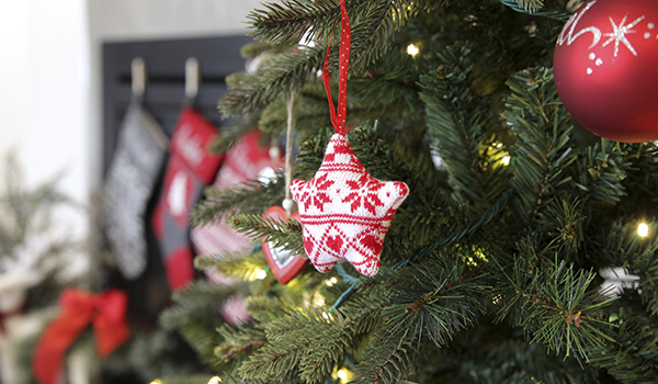Decorating your Christmas Tree - with a star shape decor hanging in a christmas tree