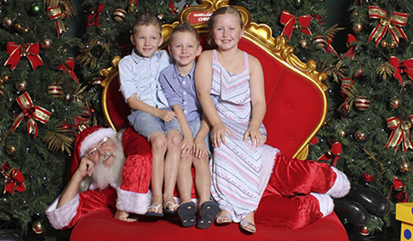 How to get the best Santa Photo - Three kids sitting on Santa claus