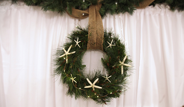 Coastal Christmas Make and Create wreath with starfish design hanging in a wall
