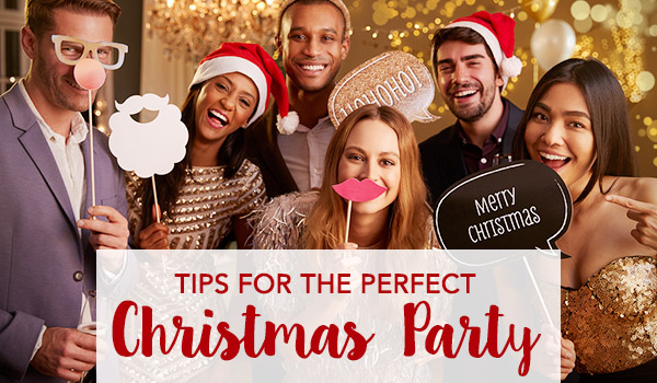 Group of friends wearing a photoshoot signs - Tips for the Perfect Christmas Party