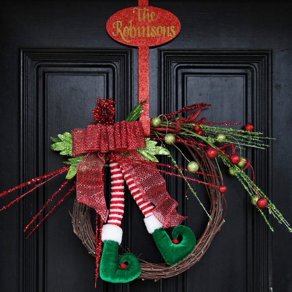 elf legs wreath on black door - Decorate Your Front Door with Christmas Flair