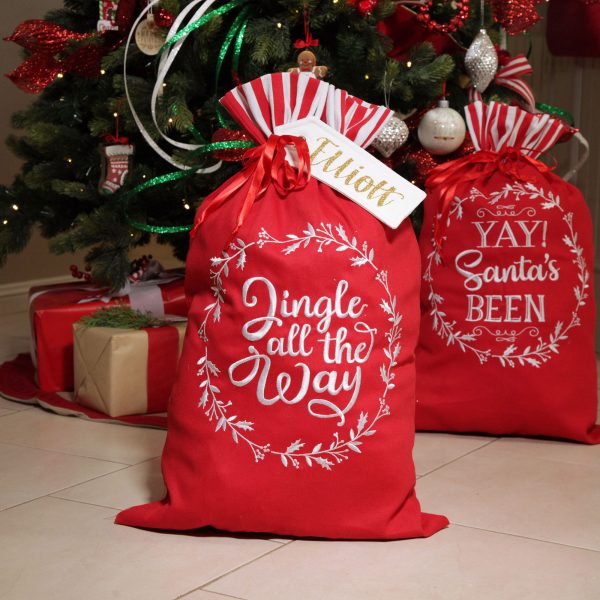 A Christmas Kitchen Personalised Jingle all the Way Santa Sack infront of a Christmas Tree