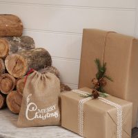 Just Sack with Printed Design Merry Christmas Beside Wood Log