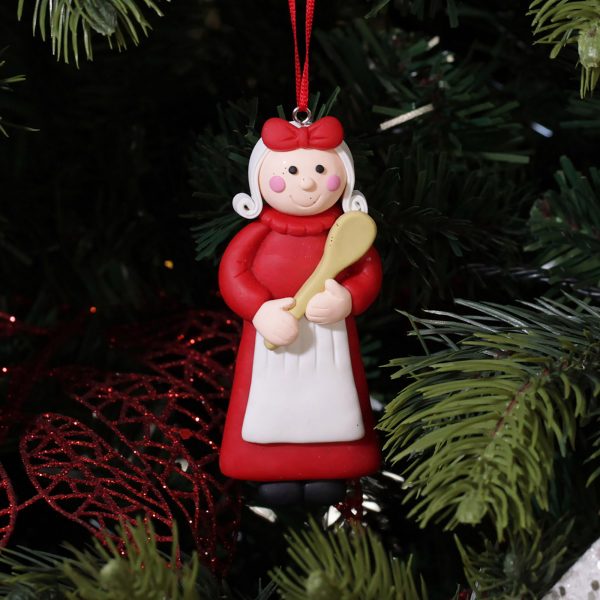 A Christmas Kitchen Baking Mrs Claus Decoration Hanging in A Christmas Tree