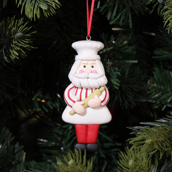 A Christmas Kitchen Baking Santa Decoration Hanging in A Christmas Tree