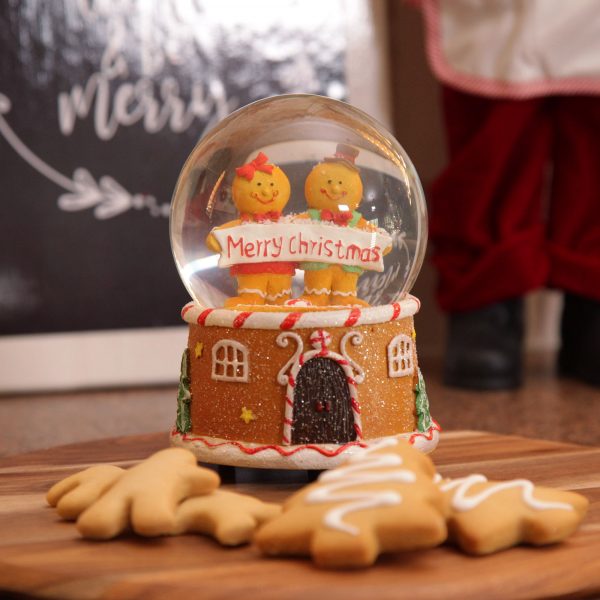 A Christmas Kitchen Gingerbread Snowglobe with gingerbread shaped tree