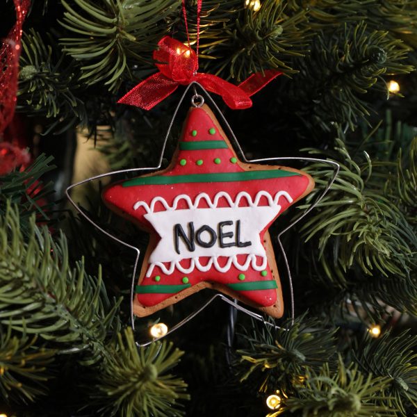 A Christmas Kitchen Gingerbread Star Cookie Cutter Decoration Hanging in a Christmas Tree