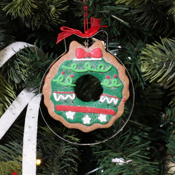 A Christmas Kitchen Gingerbread Wreath Cookie Cutter Decoration Hanging in a Christmas Tree
