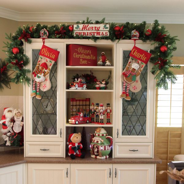 A Christmas Kitchen Hutch with personalised christmas stockings and other ornaments