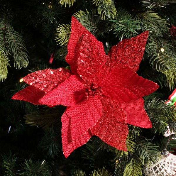 A Christmas Kitchen Red Burlap Sequin Flower placed in the Christmas Tree