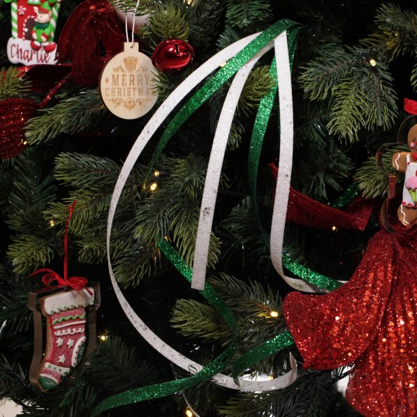 A Christmas Kitchen White Glitter Curly Ribbon Spray Placed in a Christmas Tree