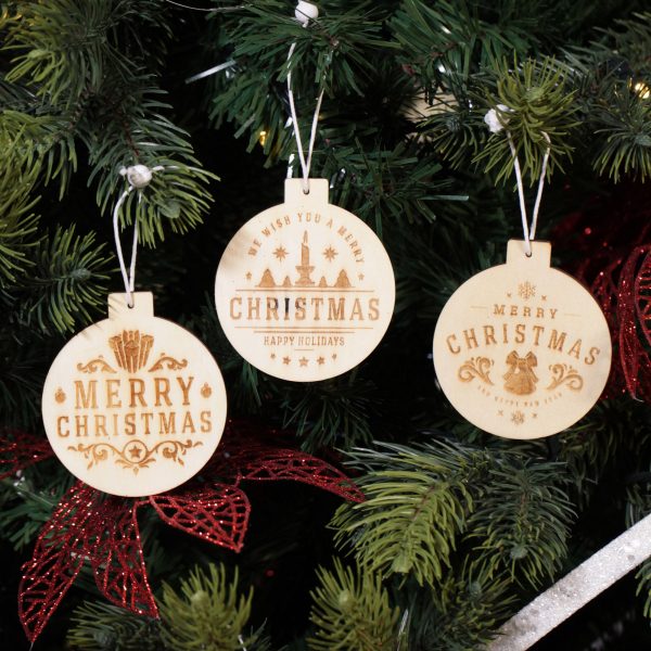 A Christmas Kitchen Wooden Bauble Shaped Tree Decoration Hanging in a Christmas Tree