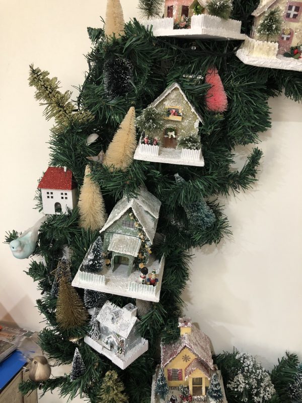 DIY Miniture Wooden House placed in a garland