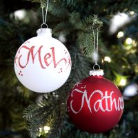 Personalised Red and White Bauble Hanging in a Christmas Tree