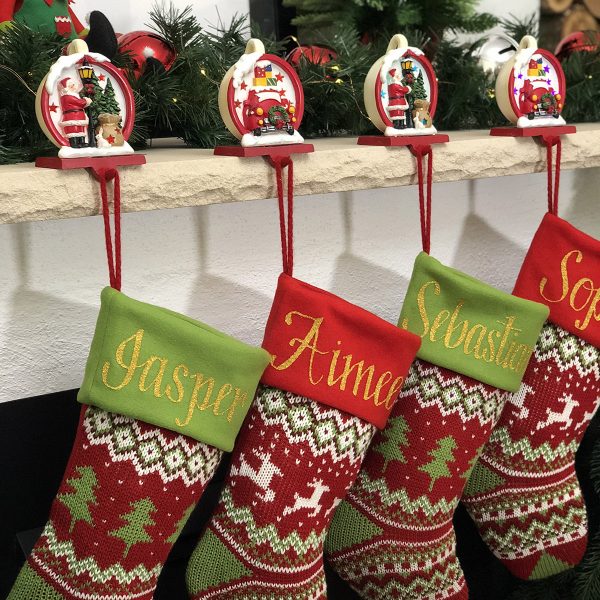 Red Green Knitted Personalised Stockings Hanging in front of a fireplace