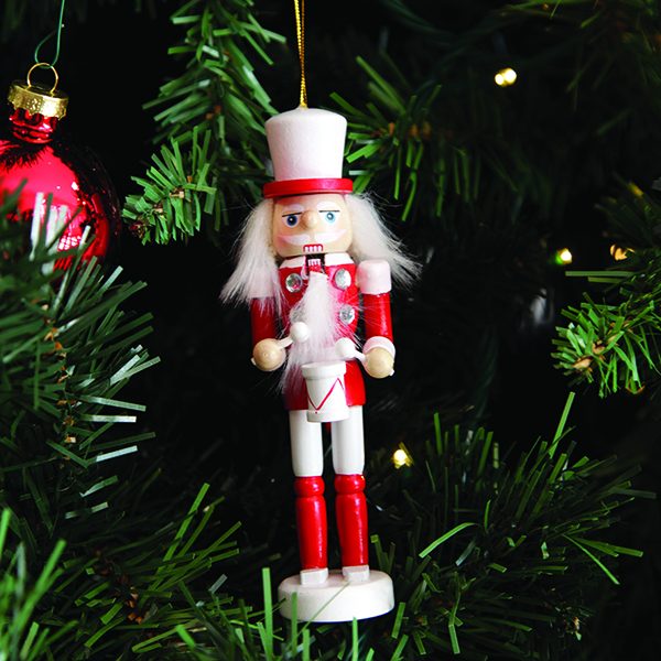 Red and White Wooden Nutcracker Tree Decoration Hanging in a Christmas Tree