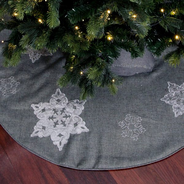 silver tree skirt under the christmas tree
