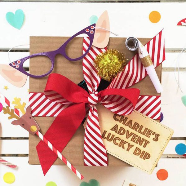 Charlies Advent Lucky Dip Tag placed in a Gift Box with Red Bow and other designs