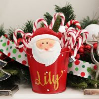 Candy Cane Christmas Personalised Santa Metal Christmas Treat Bucket Square behind is a polka dots ribbon with garlands