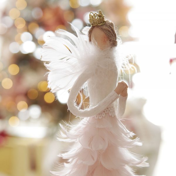 Sugar Plum Christmas Graceful Standing Pink Feather Angel blurred background of the Christmas Tree