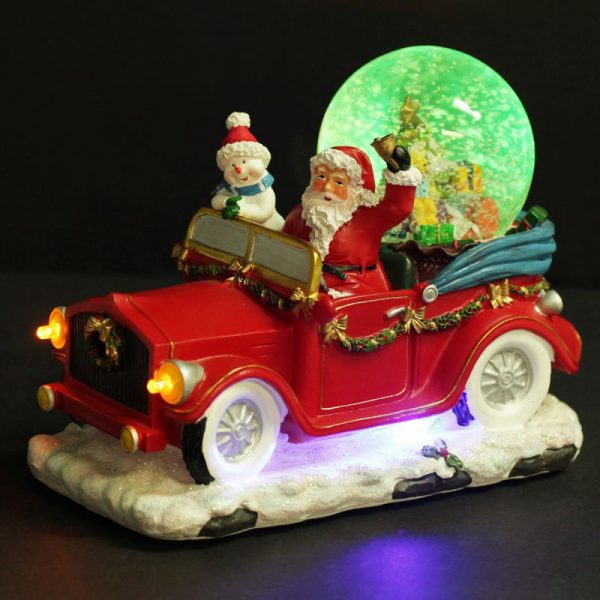 Santa and Snowman Snowglobe in red Car on Black Close up Green light placed in a black background