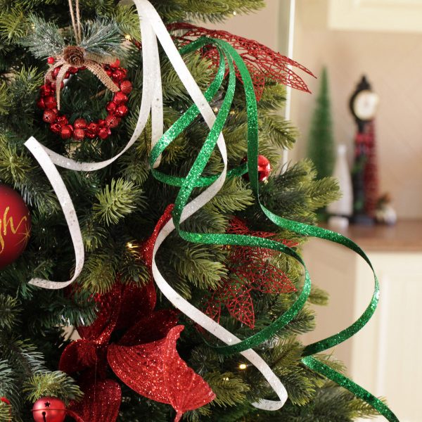 A Christmas Kitchen Green Glitter Curly Ribbon Spray Hanging in a christmas Tree