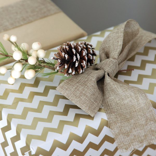 Gold and White Christmas Gifts with Small Pinecone added to the Brown Bow