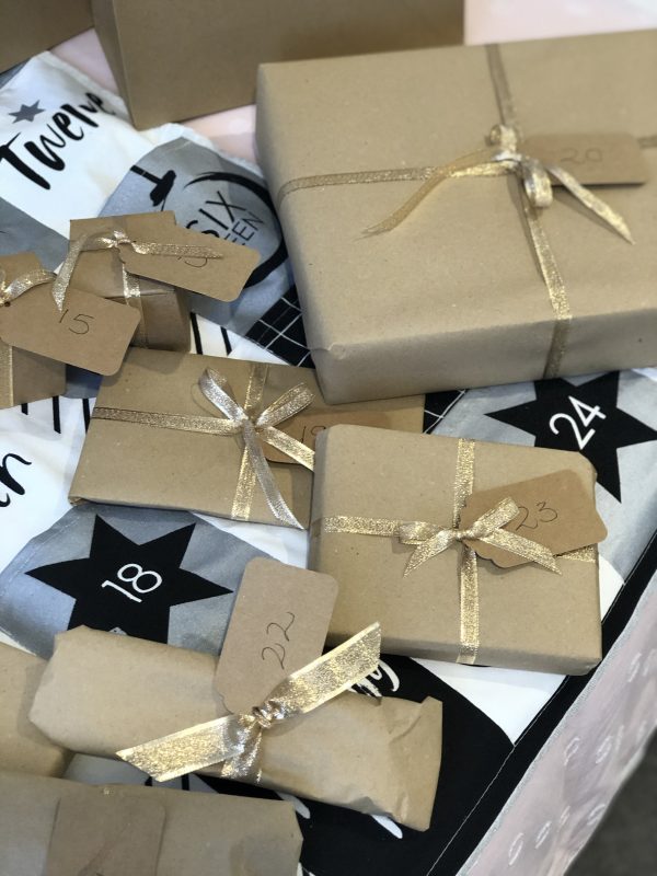 Christmas Gifts Wrapped in Brown Paper with Gold Ribbon
