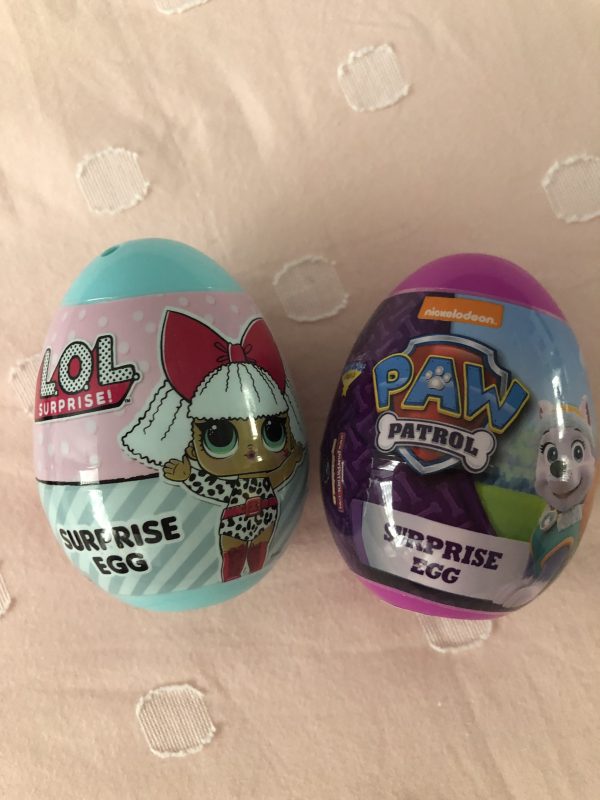 Two Egg toys with an Lol Dolls and Paw Patrol Designs