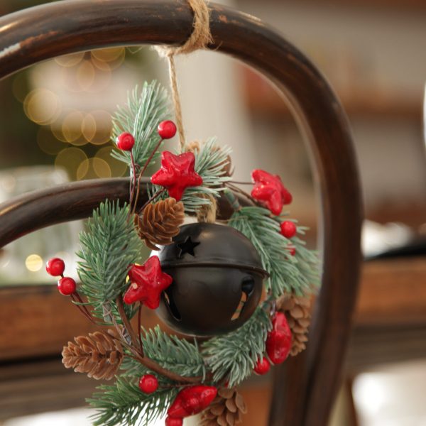 Mini Wreath with Black Bell 2 Hanging in a Wooden Chair