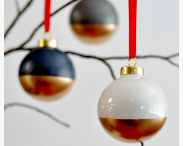 Dipped Baubles with Gold and Black Colour Hanging in a Tree Branch