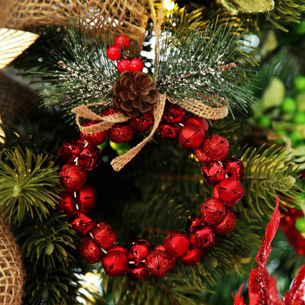 Red nut Bell Wreath with Pine Hanging in a Christmas Tree