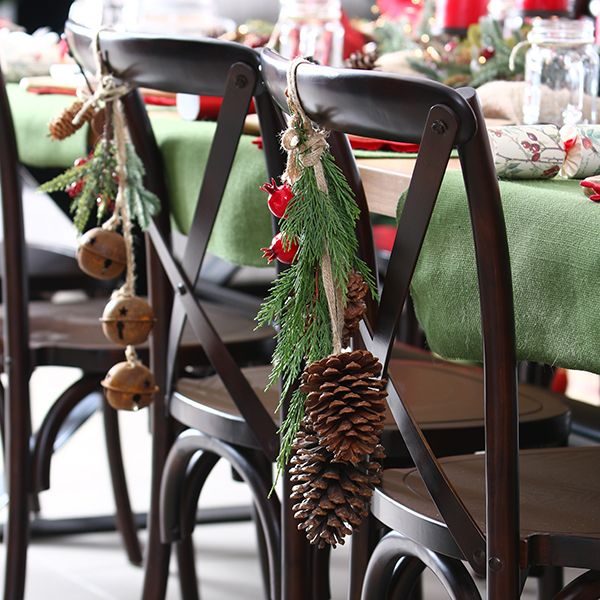 Rustic Lifestyle Chairs with bells and pinecones hanging in a chair