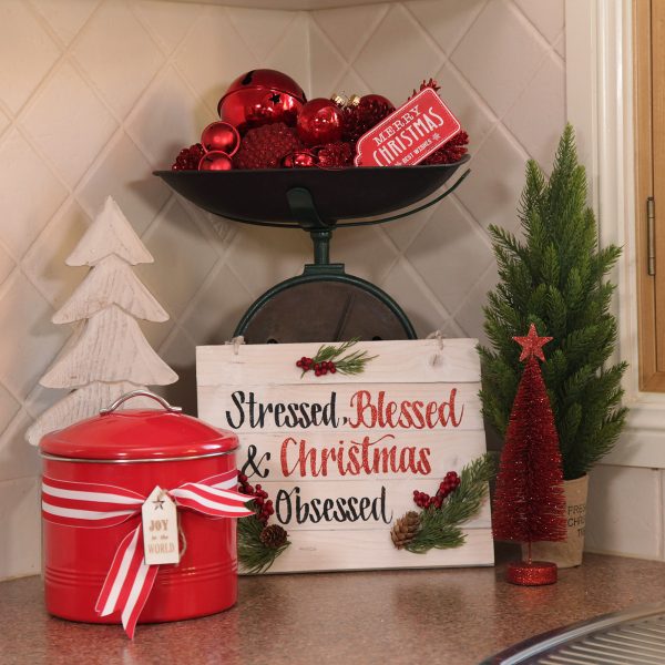 A Christmas Kitchen Oven Range Vignette with Stressed Blessed & Christmas Obsessed Plaque and Red Bottle Brush Tree