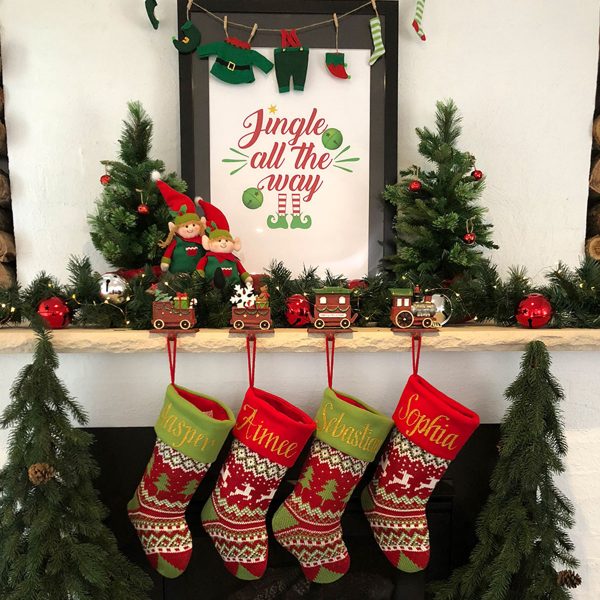 Personalised Christmas Stockings Hanging in a fireplace with Jingle all the way poster and Stocking Hanger