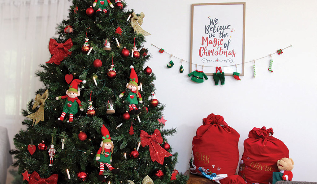 Christmas Tree with Elf Girl and boy Hanging We Believe in the Magic of Christmas Poster Download and Personalised Red Sack Featured Image