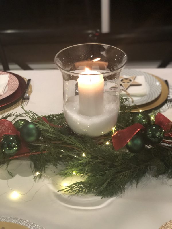 Hurricane Candle placed in a table with garland