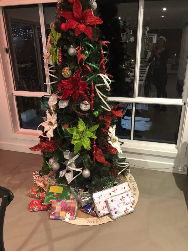 Christmas Tree with Donated Gifts Under placed in the living room