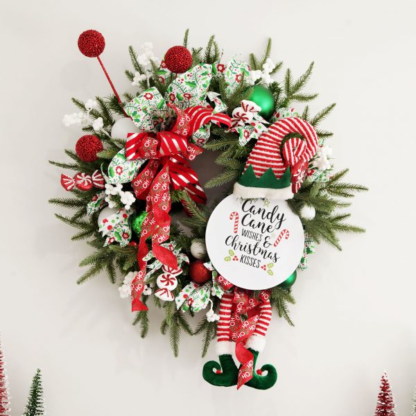 Candy Cane Christmas DIY Wreath Hanging in a White Wall