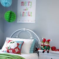 Pom Pom Santa Christmas Cushion Cover and Merry and Bright Poster Download hanging in a wall