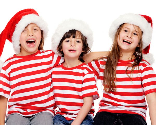 Three Happy kids wearing Stripe Shirts Red and White with Santa Hats
