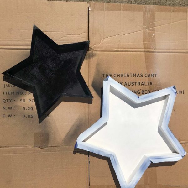 Two stars repainted to the back and placed on a carton
