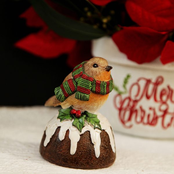 Bird with Scarf on Pudding placed in front of a Merry Christmas Vase