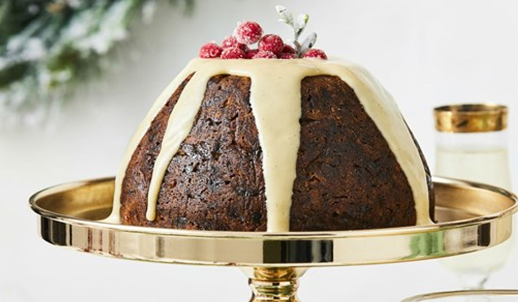 Christmas Pudding with White Cream and Red Berry on top Placed in a Golden tray Featured Image