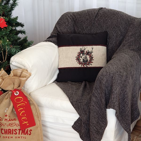 Vintage Reindeer Christmas Cushion Wrap Placed in a Chair