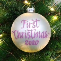 First Christmas Girl Personalised Christmas Bauble Hanging in a Christmas Tree