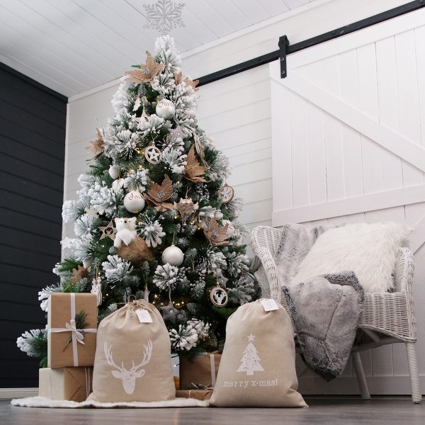 Hygge Room With a Huge Christmas Tree with Santa Sack with a Deer and Christmas Tree Design